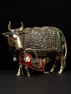 Brass cow statue with horned head and calf, decorative engravings on body panels