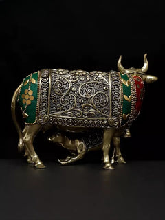 Brass cow figurine, side view: green enamel panels, red trim, detailed metal filigree
