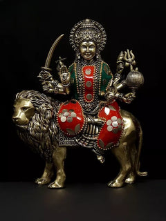 Brass Durga statue riding lion, goddess with trident and four arms, red accents