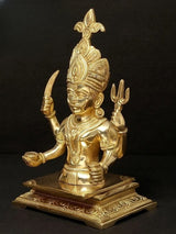 Gold brass Nakoda Deity of the Jains idol, seated, raised hands, side view.