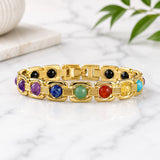 Gold chakra gemstone bracelet with purple, blue, green, red, and yellow stones on links