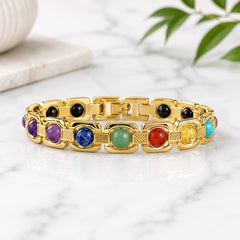 Gold chakra gemstone bracelet with purple, blue, green, red, and yellow stones on links
