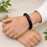 Black ebony wood kada bracelet on wrist, smooth round bangle