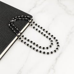 Black bead necklace with silver-toned connectors and matching bracelet set