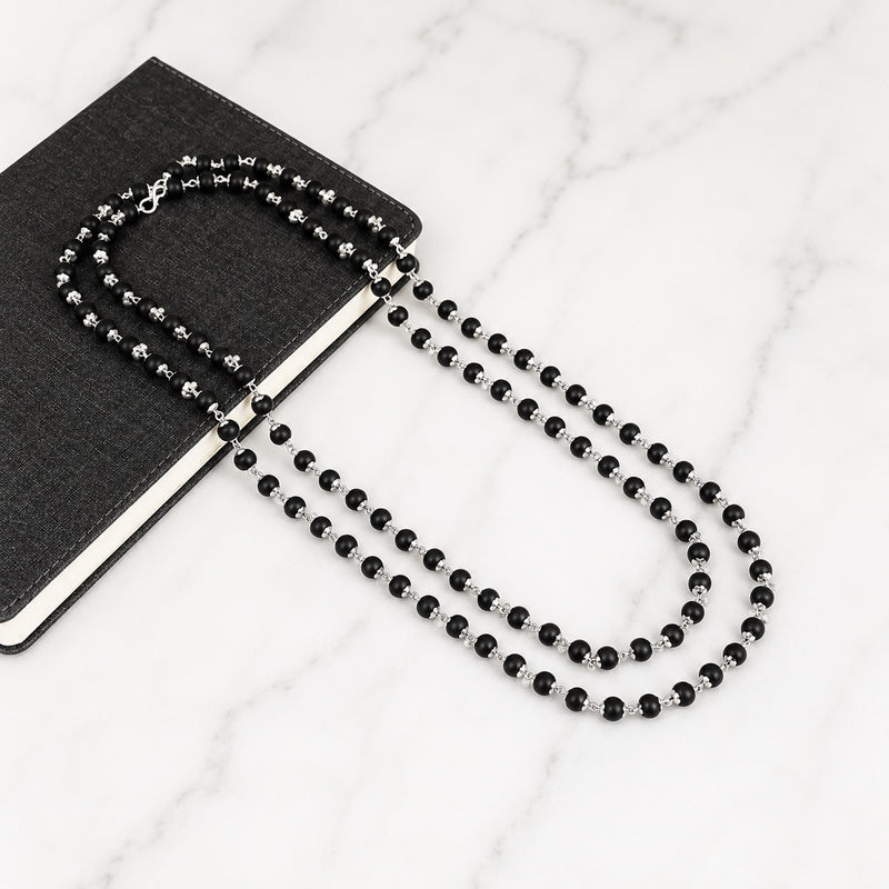 Black beaded necklace with silver-toned accents and matching bracelet, loop clasp