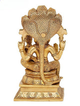 Back view of brass Narasimha statue with serpentine frame, seated on pedestal