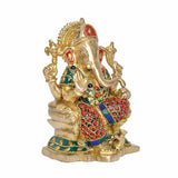 Side view brass Ganesha idol with jeweled belt, red patterned dhoti, gold trunk