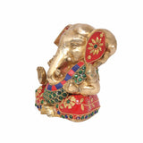 Brass Lord Ganesha idol in side view, red-and-green jeweled drape