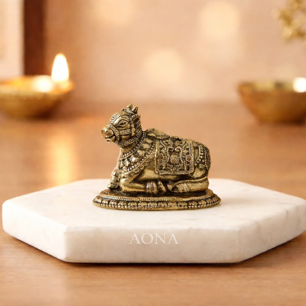 Brass Nandi bull idol, detailed ornate patterns, seated on round base