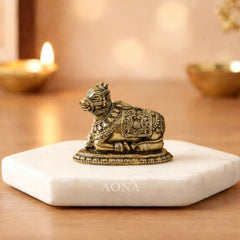 Brass Nandi bull idol, detailed ornate patterns, seated on round base