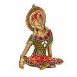 Brass Indra statue, front view; red crown, gold face, teal beadwork and red jeweled skirt.