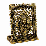 Brass dashboard panel with carved deity face in teardrop frame, raised detailing