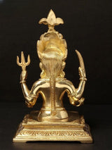 Back view of brass Nakoda Deity of the Jains figurine, seated with raised arms.