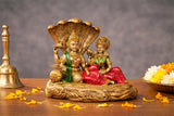 Resin Vishnu and Lakshmi statue on Sheshnag, gold base with green and red outfits