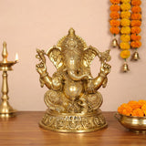Brass golden Ganesha murti with ornate crown and four raised arms, decorative home idol