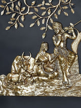 Brass Radha Krishna seated under tree; close-up of figures and branching leaves