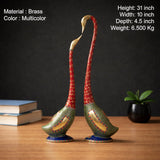 Multicolored brass swan pair with red necks and green patterned bodies, upright