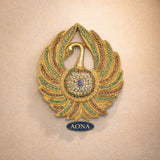 Brass peacock wall hanging with gem-studded fan and bell center, AONA logo