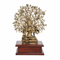 Brass Tara Devi seated statue with radiating tree canopy on wooden base