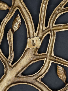 Brass tree wall hanging close-up of branches, leaves, and padlock