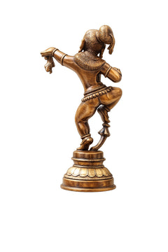 Brass Krishna statue from behind, curved arms and coiled hair on base