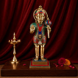 Brass Hanumanji statue with painted ornaments and colorful garland, standing on base