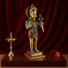 Brass Hanumanji statue holding a mace, wearing jeweled red-and-green outfit