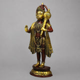 Standing Hanuman statue in gold-tone with layered garlands and arched tail, copper base
