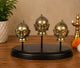 Brass Gauri/Parvati head idols on round dark base, three faces
