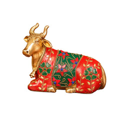 Brass Nandi bull idol with red and green painted stonework, reclining pose
