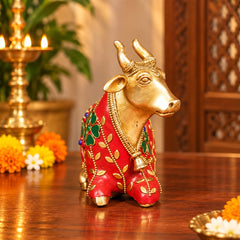 Brass Nandi bull idol with red-and-green stonework cloth, standing side view