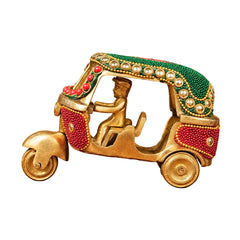 Decorative brass auto rickshaw ornament with green roof, red bead inlay, gold wheels