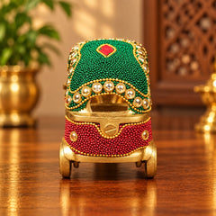 Decorative brass auto rickshaw ornament, front view with green top panel and red bead body