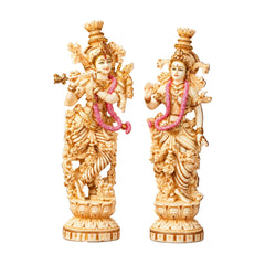 Two hand-painted marble dust statues of Radha and Krishna, front view with pink accents