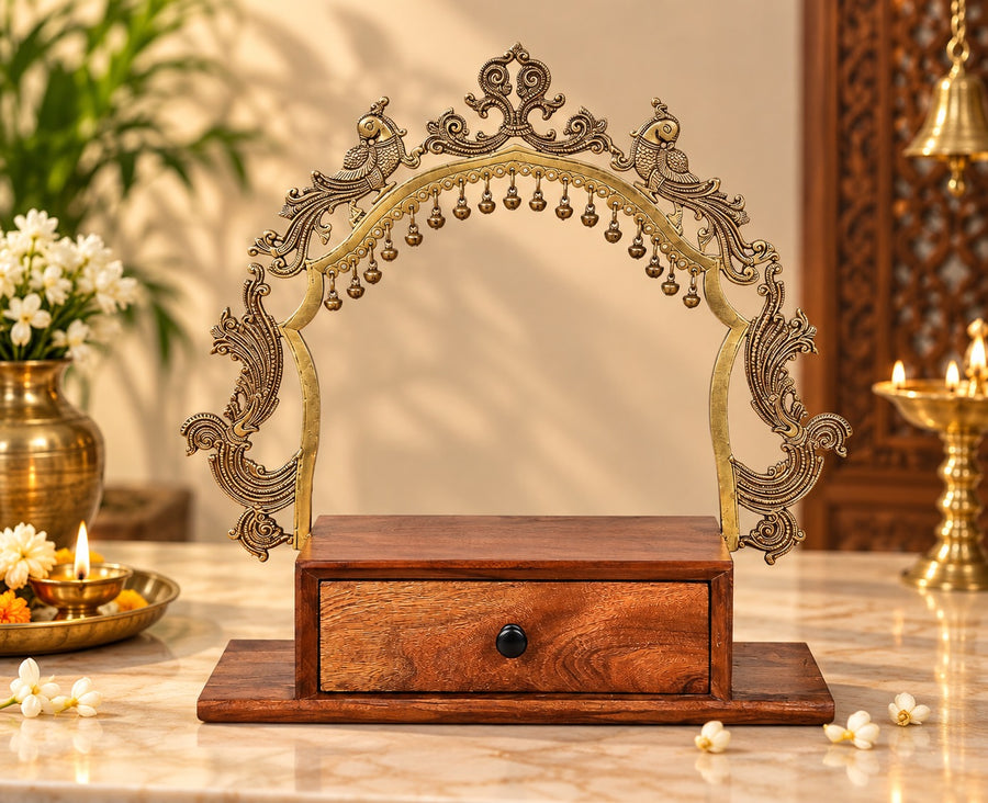 Decorative temple altar with ornate brass arch, hanging bells, and front wooden drawer