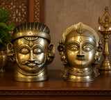 Brass Shiva and Gauri head sculptures on display base, gold and silver deity faces