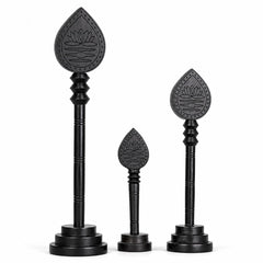 Set of three dark wooden vel sticks with engraved lotus teardrop heads and bases