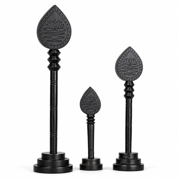 Set of three dark wooden vel sticks with engraved lotus teardrop heads and bases