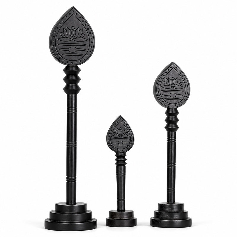 Set of three dark wooden vel sticks with engraved lotus teardrop heads and bases