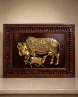 Brass cow and calf relief wall art inside richly carved wooden frame
