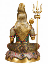 Brass Lord Shiva statue seated, back view with trident; multicolor jeweled garment