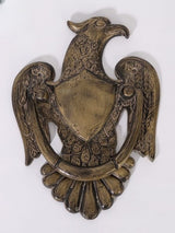Antiqued brass eagle door knocker with engraved wings and shield