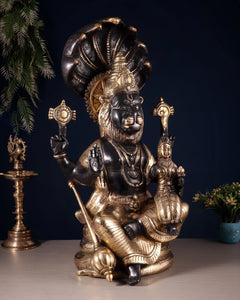 Brass Narsimha Lakshmi statue, side view showing crown, arms, and seated pose