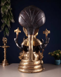 Rear view of large brass Narsimha Lakshmi statue with cobra hood details