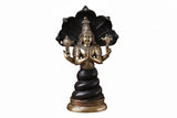 Black-and-gold Patanjali yoga statue, side view with raised hands and lotus seat.