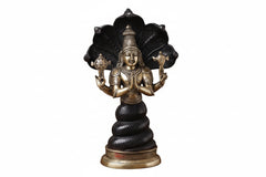 Black-and-gold Patanjali yoga statue, side view with raised hands and lotus seat.