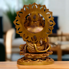 Back view of brass Hanuman ji sitting idol with gada, circular halo ornament.