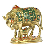 Brass cow and calf sculpture, green-and-gold inlay with red eye and floral accents