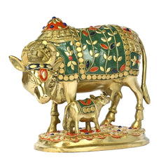 Brass cow and calf sculpture, green-and-gold inlay with red eye and floral accents
