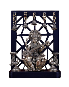 Brass Saraswati idol on lotus with hanging bells and annam-style oil lamps